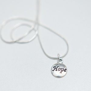 22 inch silver necklace with charm that says hope